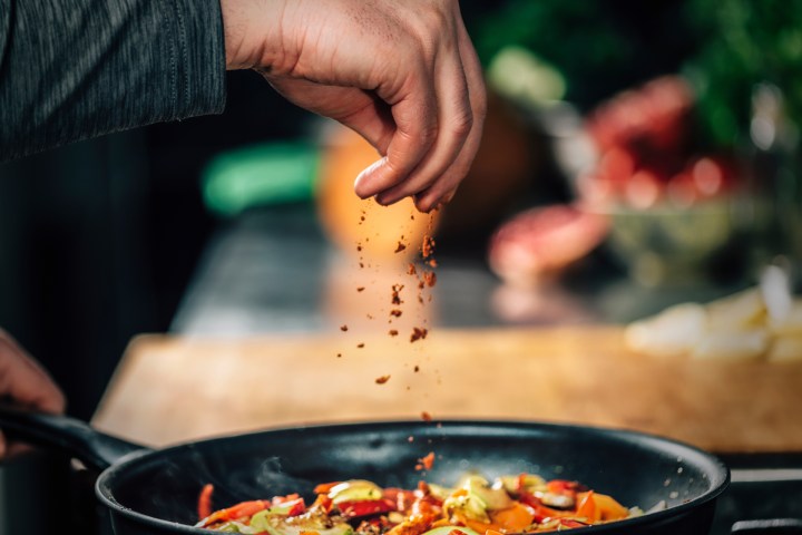 a person cooking food in a bowl