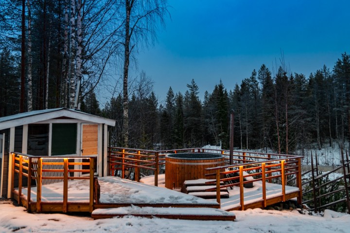a wooden bench covered in snow